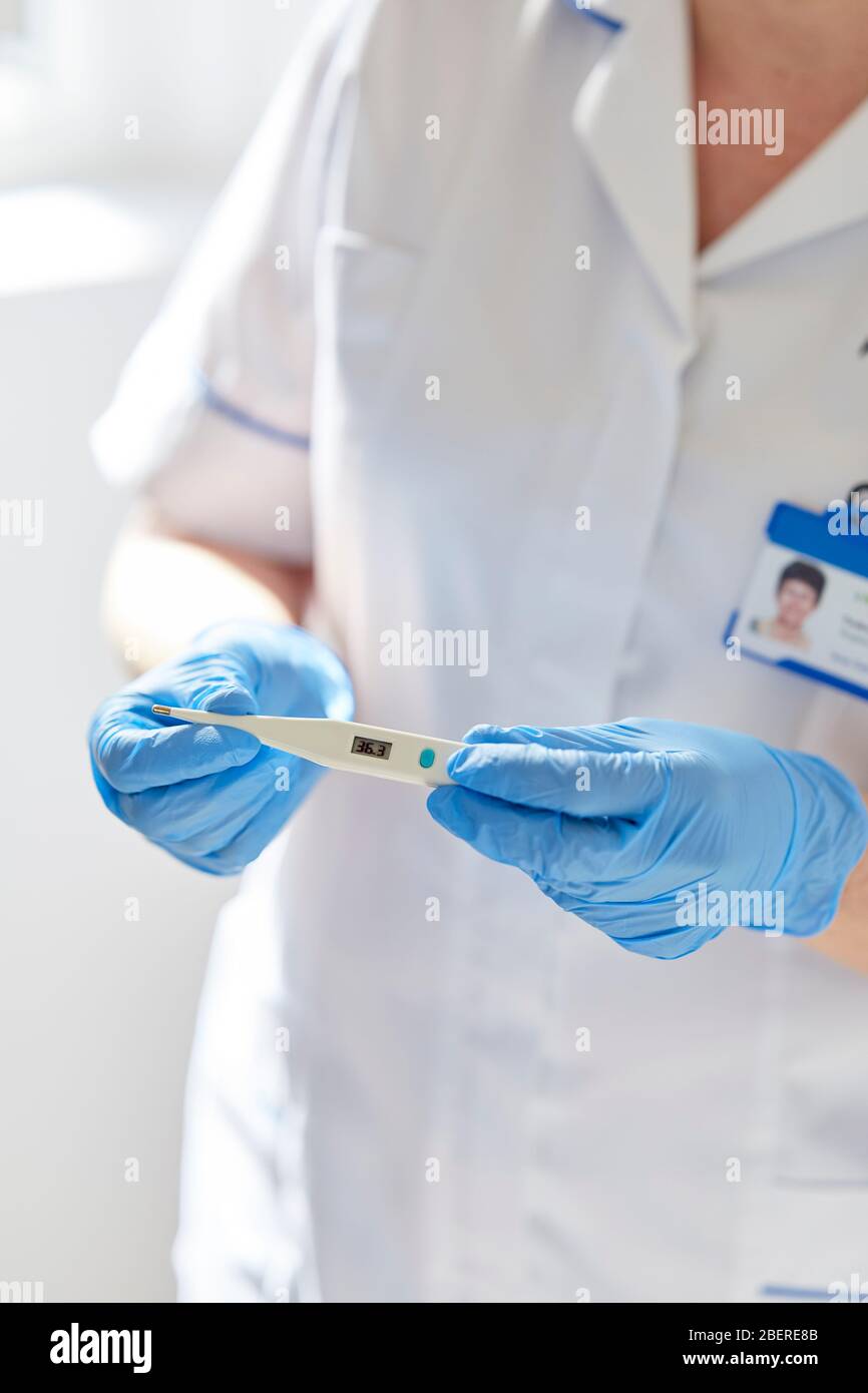 Nurse holding thermometer Stock Photo