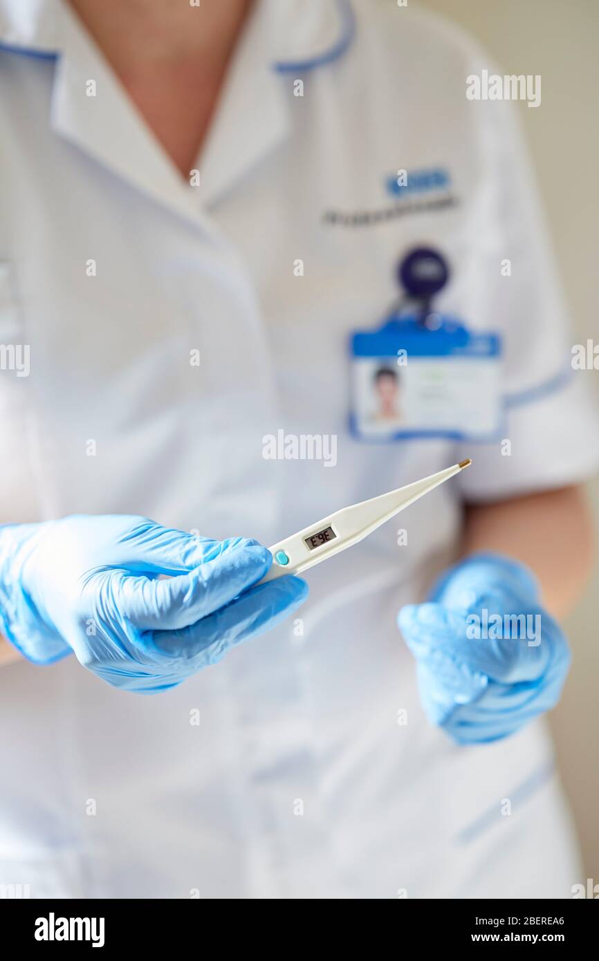 Nurse holding thermometer Stock Photo