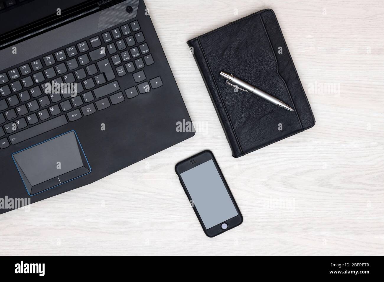 Home workspace with blank smartphone screen and laptop computer Stock Photo