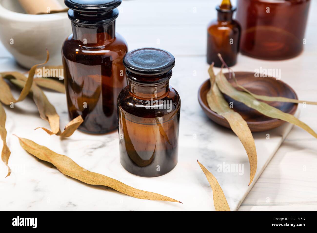 Eucalyptus essential oil on vintage amber bottle. herbal oil for skin care, aromatherapy and natural medicine Stock Photo