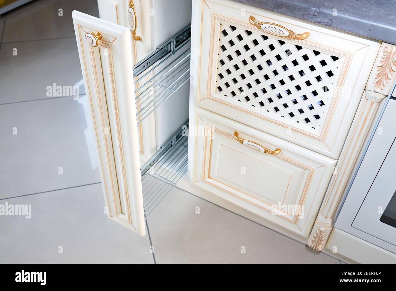 Interior of modern kitchen in classic style with golden elements in