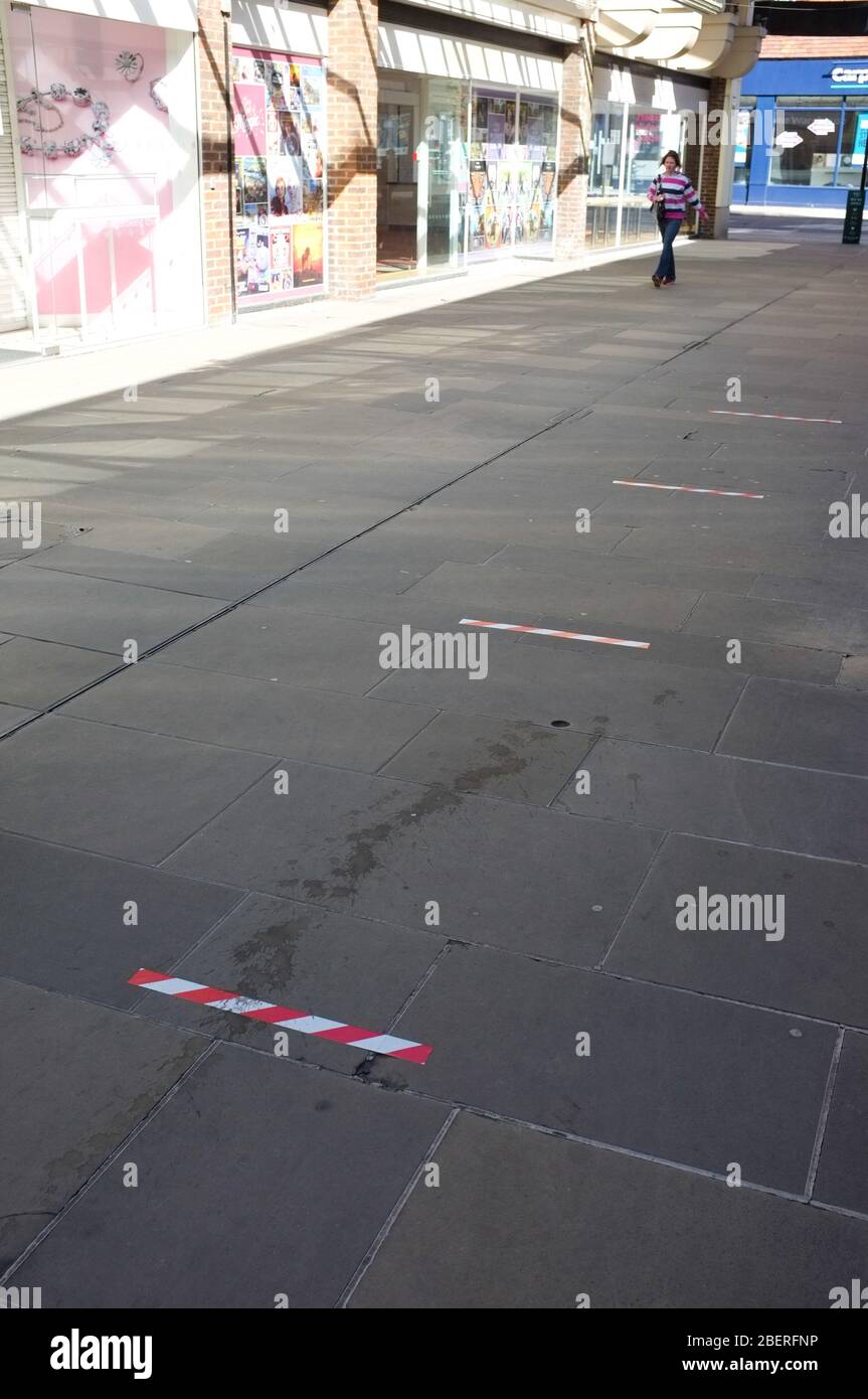 Social distance markers in a Salisbury city centre arcade during the coronavrus lockdown which ensure queuing public keep 2m apart. April 2020. UK. Stock Photo