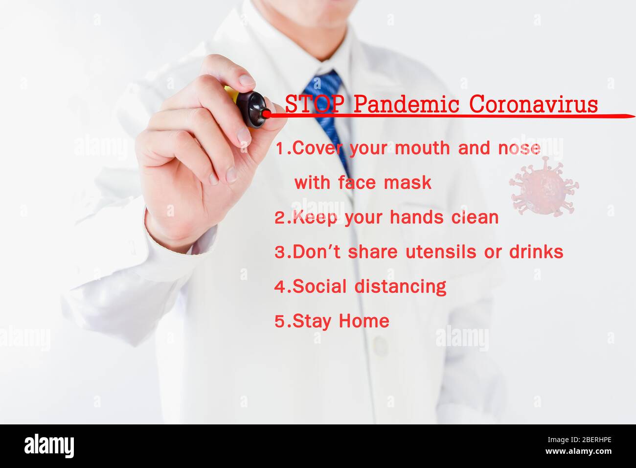 Doctor hand is writing a method to STOP Pandemic Coronavirus on transparent screen Stock Photo
