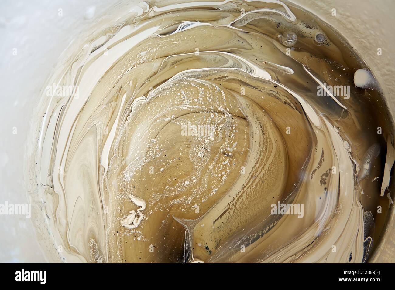 Partially stirred exterior house paint in a pot Stock Photo