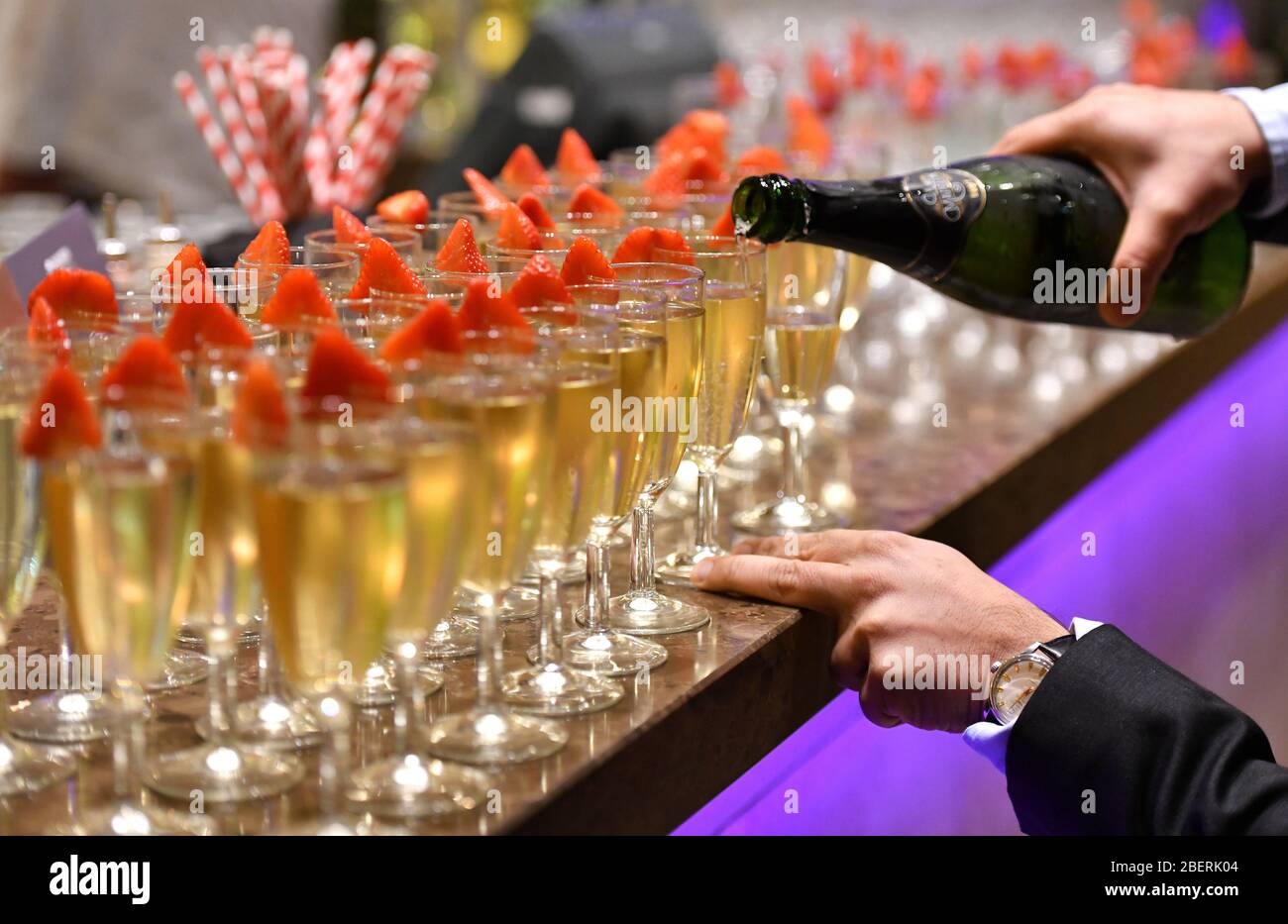 Champagne glasses being filled up at a corporate hospitality event in