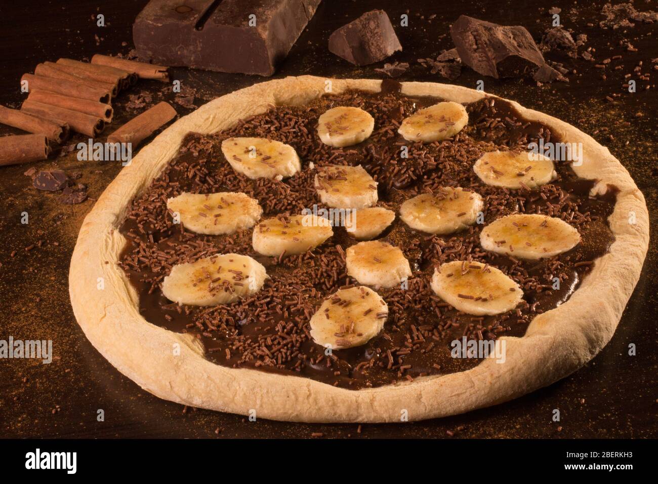 Sweet banna pizza with sliced banana and melt chocolate Stock Photo