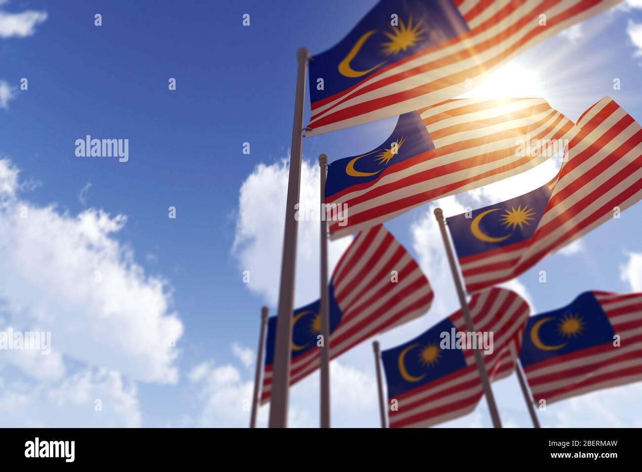Malaysia flags waving in the wind against a blue sky. 3D Rendering Stock Photo