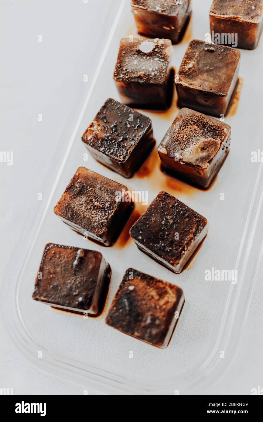 https://c8.alamy.com/comp/2BERNG9/ice-cubes-made-with-coffee-in-ice-cube-tray-to-prepare-refreshing-coffee-drinks-like-iced-coffee-white-background-high-angle-view-2BERNG9.jpg