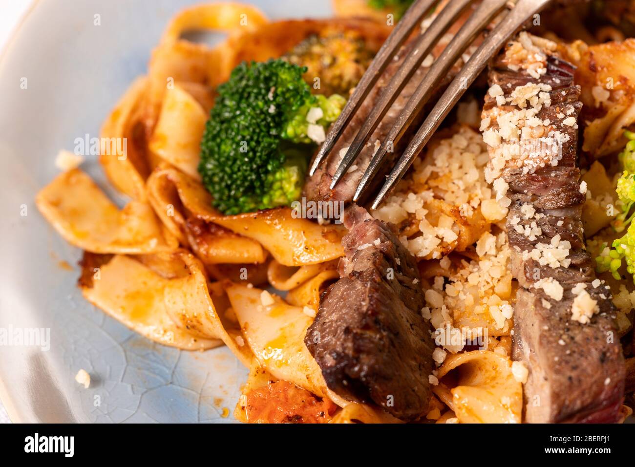 tagliatelli with steak slices on a plate Stock Photo