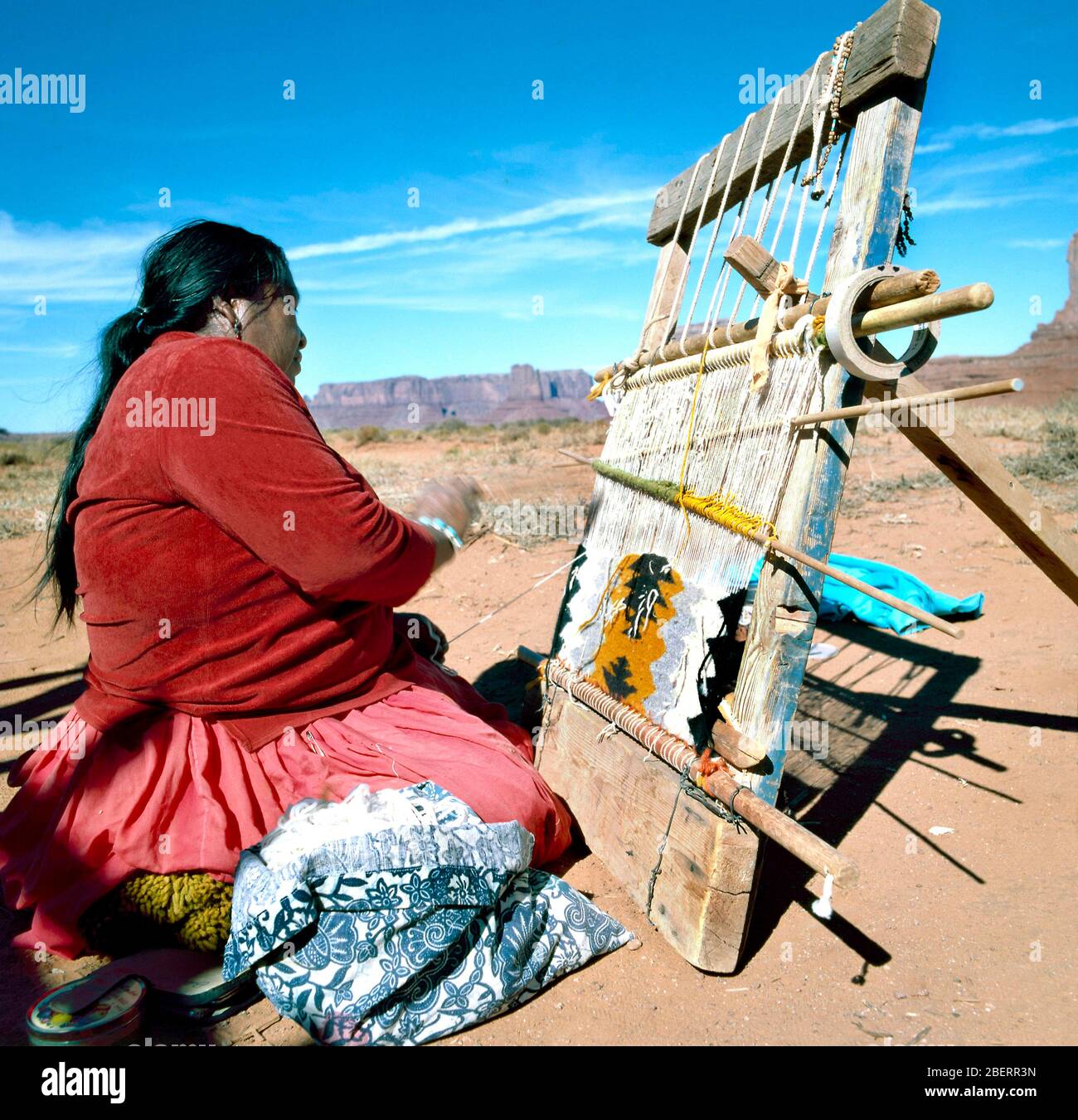 Monument Valley, U.S.A.-September 19,2001: Navajo Indian Woman Weaving Rug at Monument Valley, Utah, U.S.A. Stock Photo