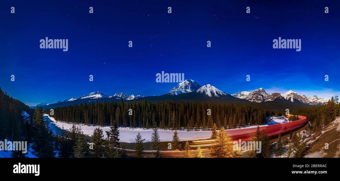 Night train in the moonlight at Morant's Curve in Banff National Park, Canada. Stock Photo