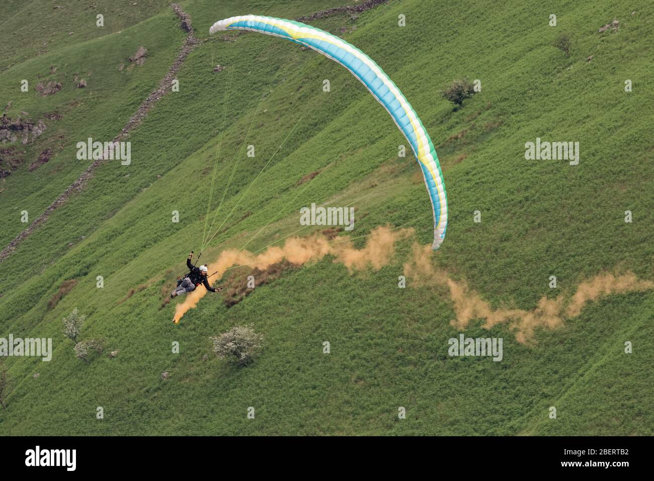 Paraglider performing an aerobatic display above Buttermere in the Lake District during the 2017 Buttermere Bash charity event Stock Photo
