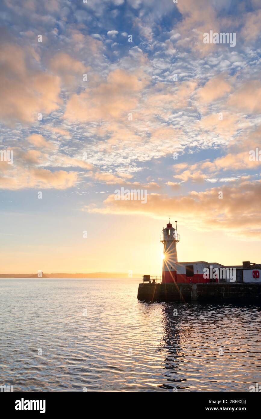 Lighthouse and entrance to Newlyn Harbour, Cornwall Stock Photo