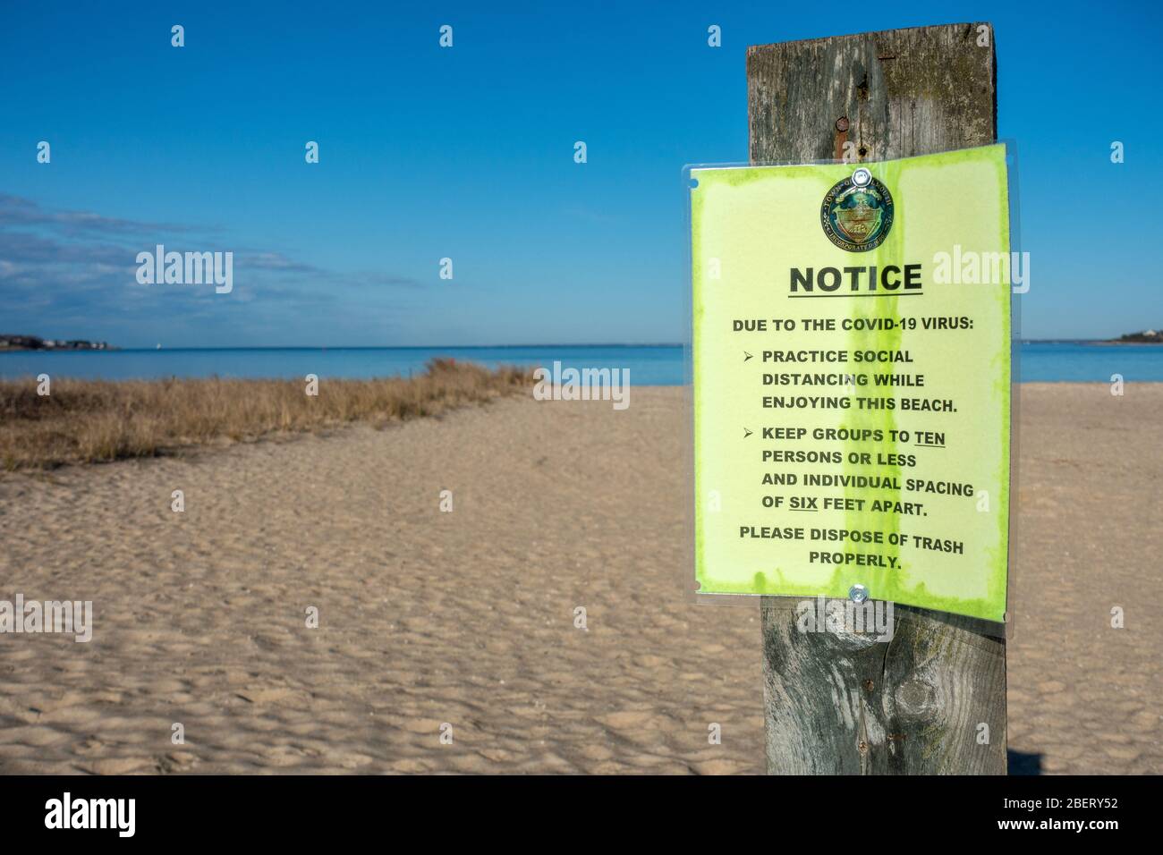 Covid-19 Virus Notice at beach for social distancing of six feet apart and groups ten people or less Stock Photo