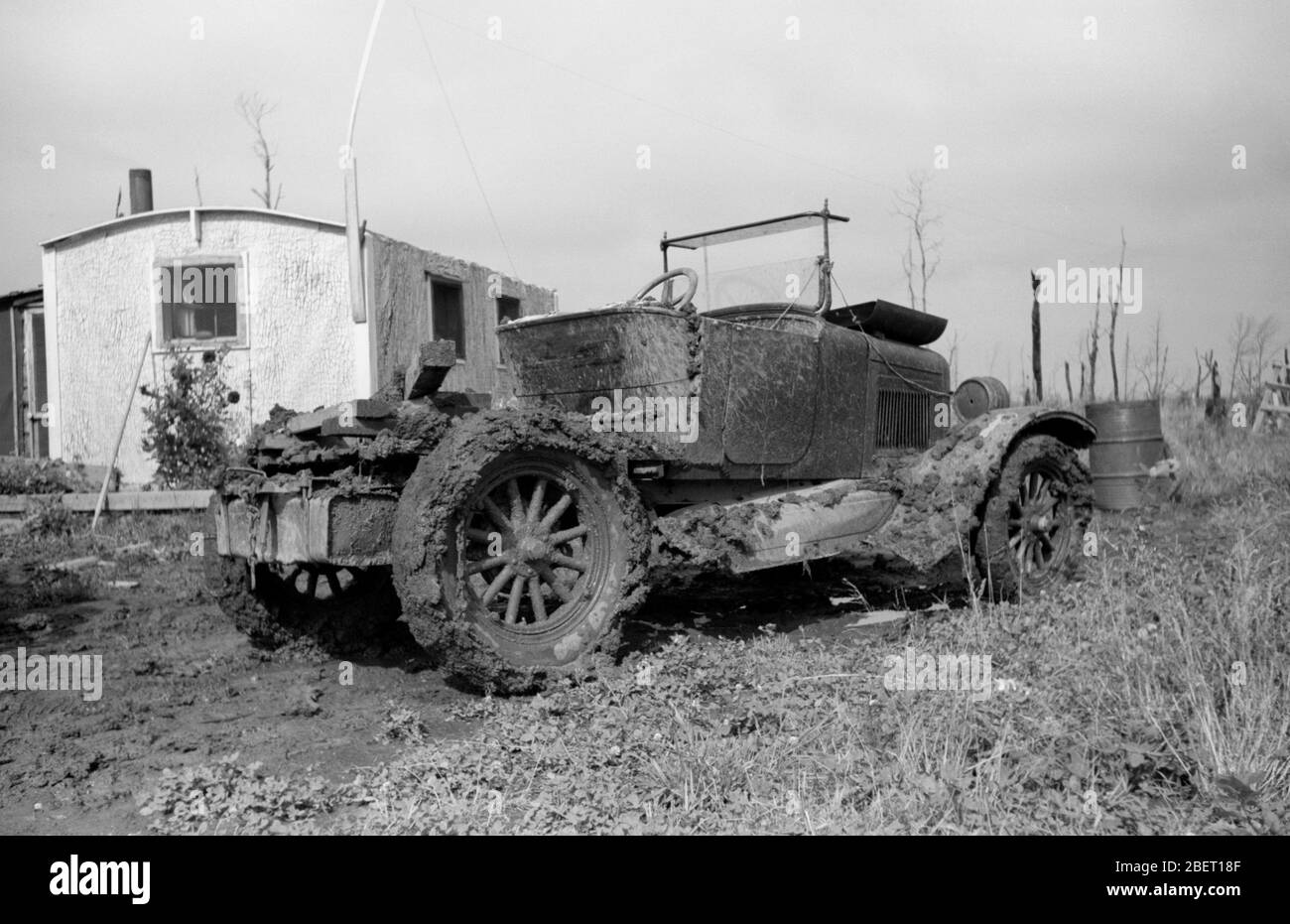 An early rat rod or chopped car on a day after mudding in the fields. Stock Photo