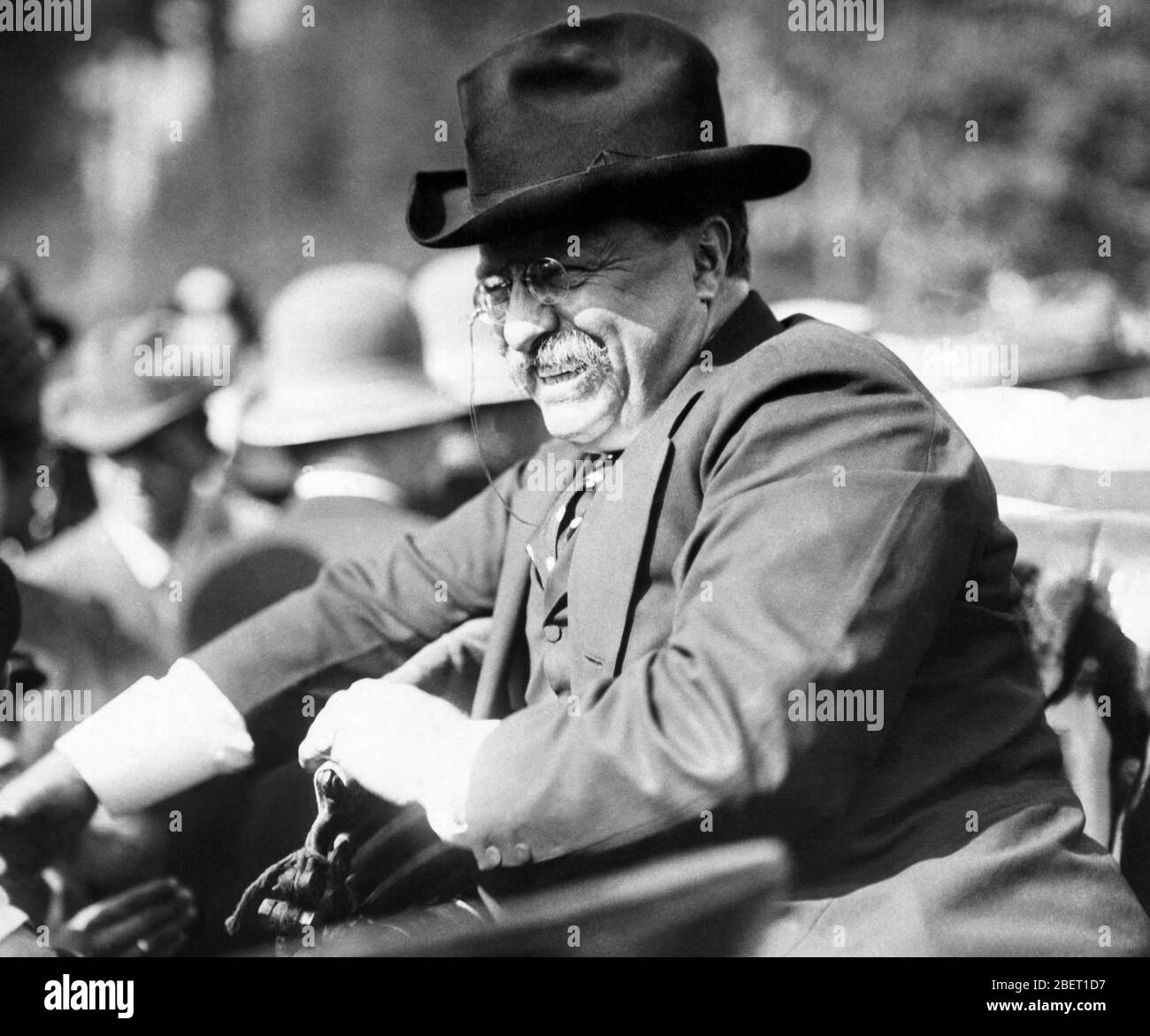 Theodore Roosevelt riding in a car with a big smile on his face, 1910. Stock Photo