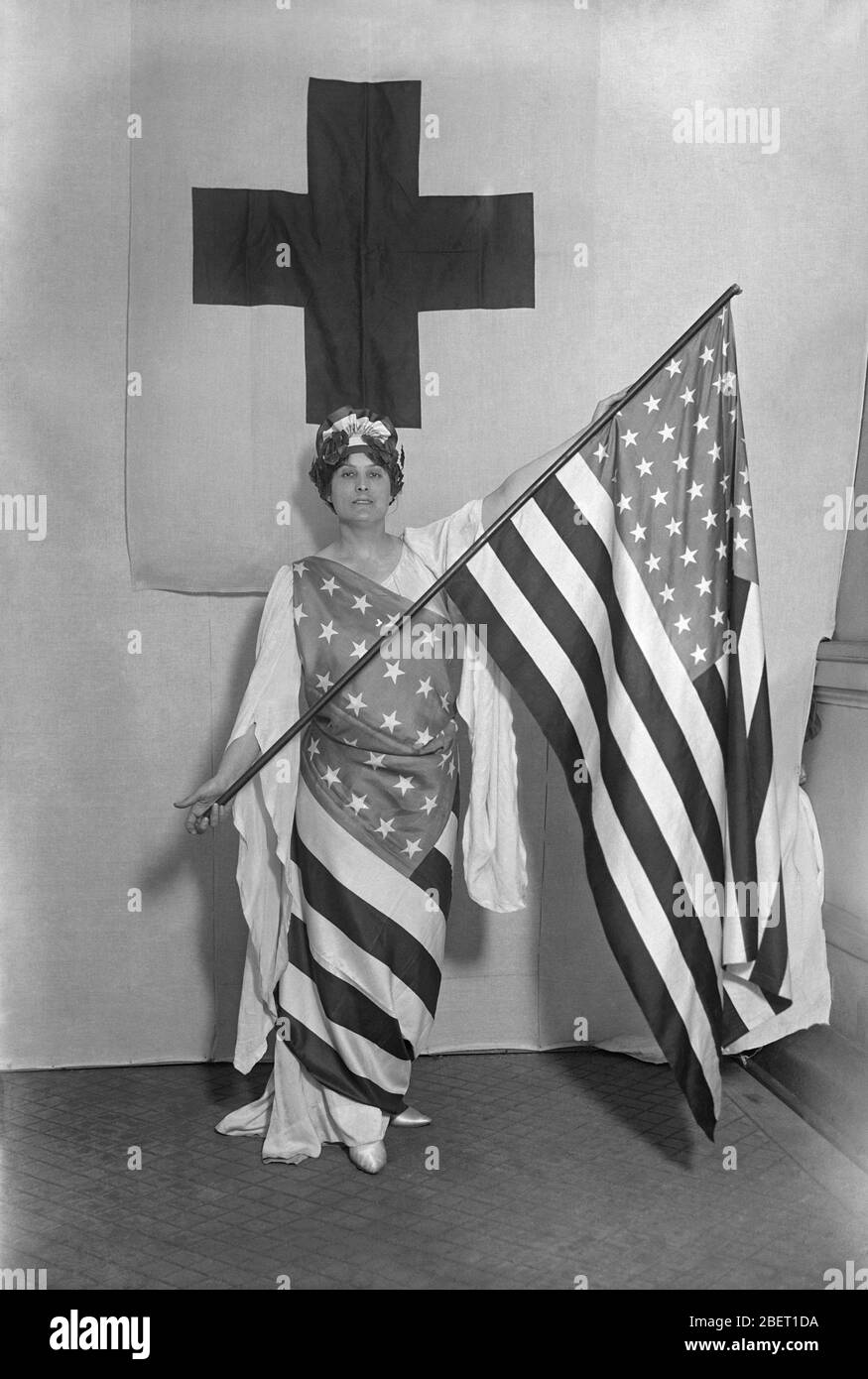 Marcia Van Dresser wearing an American flag and holding another American flag. Stock Photo