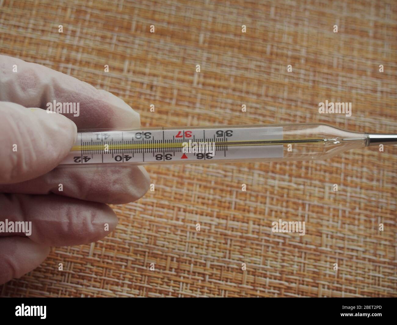 The thermometer shows the normal body temperature. Conducting health