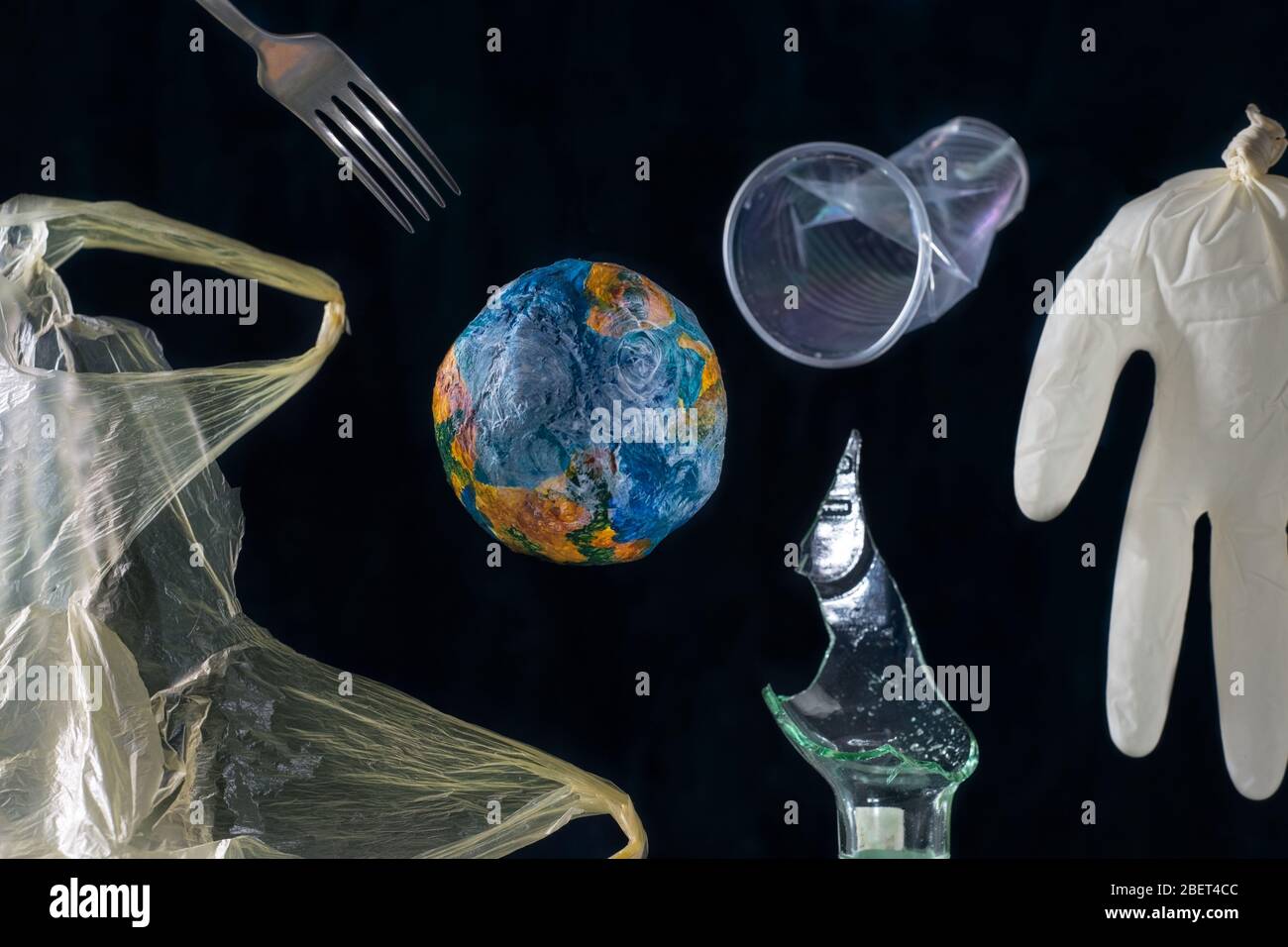 The concept of planet Earth pollution by plastic, metal, polyethylene ...