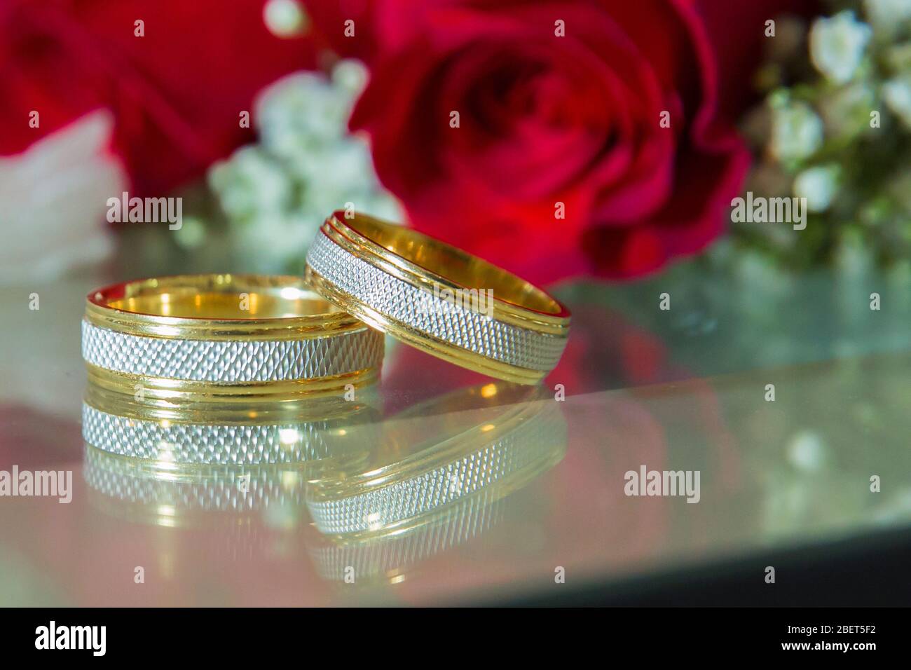 Gold Wedding Rings Of Bride And Groom On Gold Gliter Background Stock  Photo, Picture and Royalty Free Image. Image 124613309.