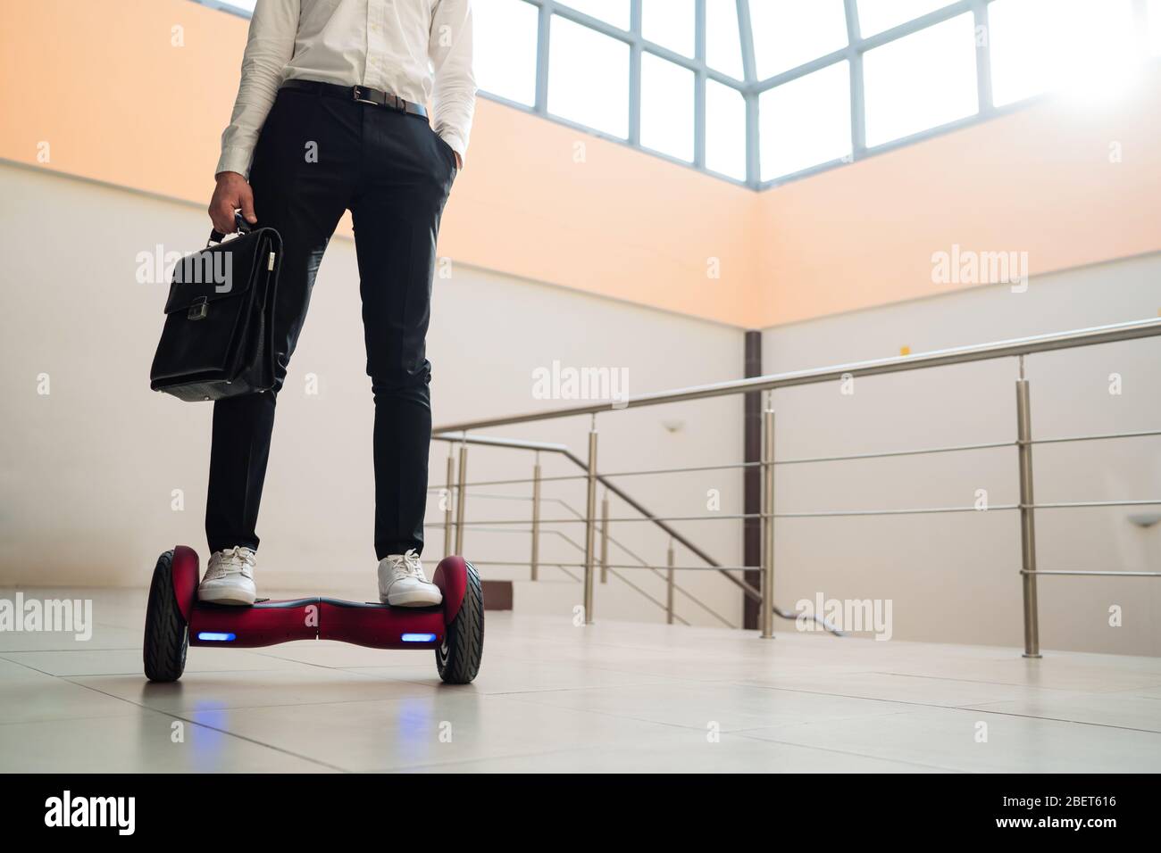 Young businessman is riding a gyroboard Stock Photo