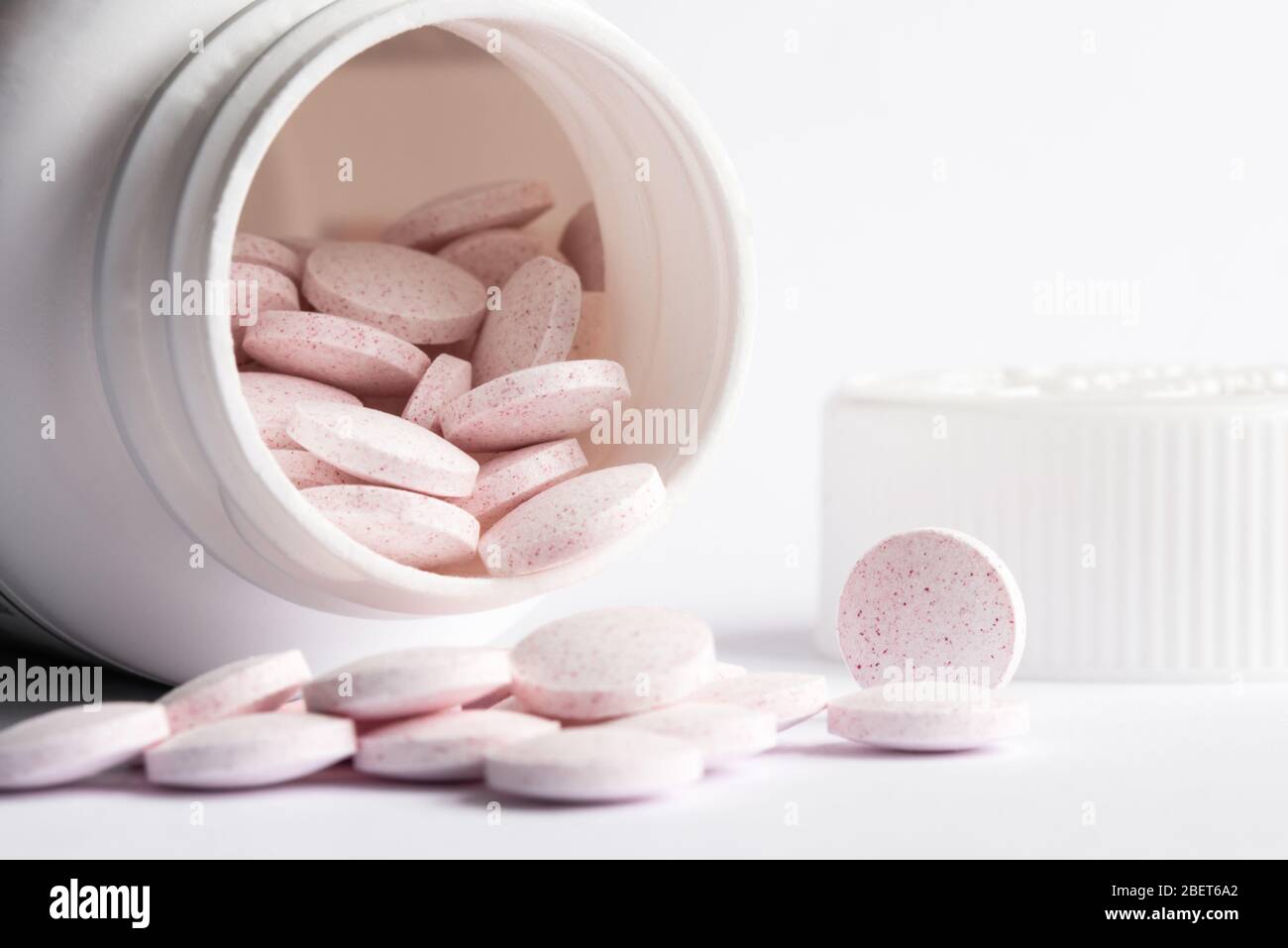 Melatonin Tablets Spilled from a Bottle Stock Photo