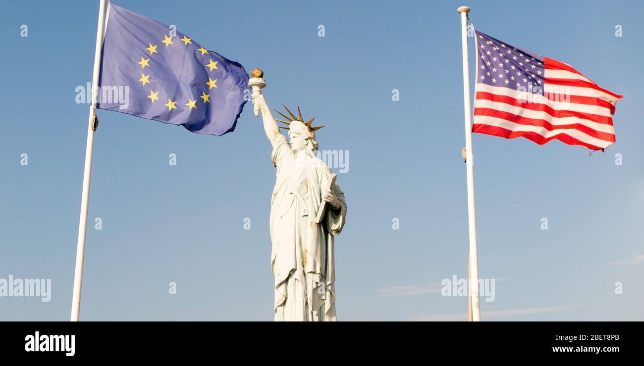 Ellis Island with statue of liberty and usa europe flag in wind Stock Photo