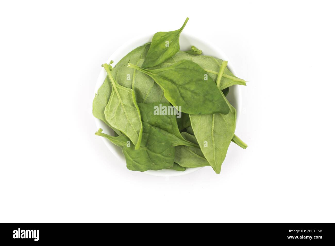 Brazilian Spinach in a bowl. Spinacia oleracea over a white background. Top view Stock Photo