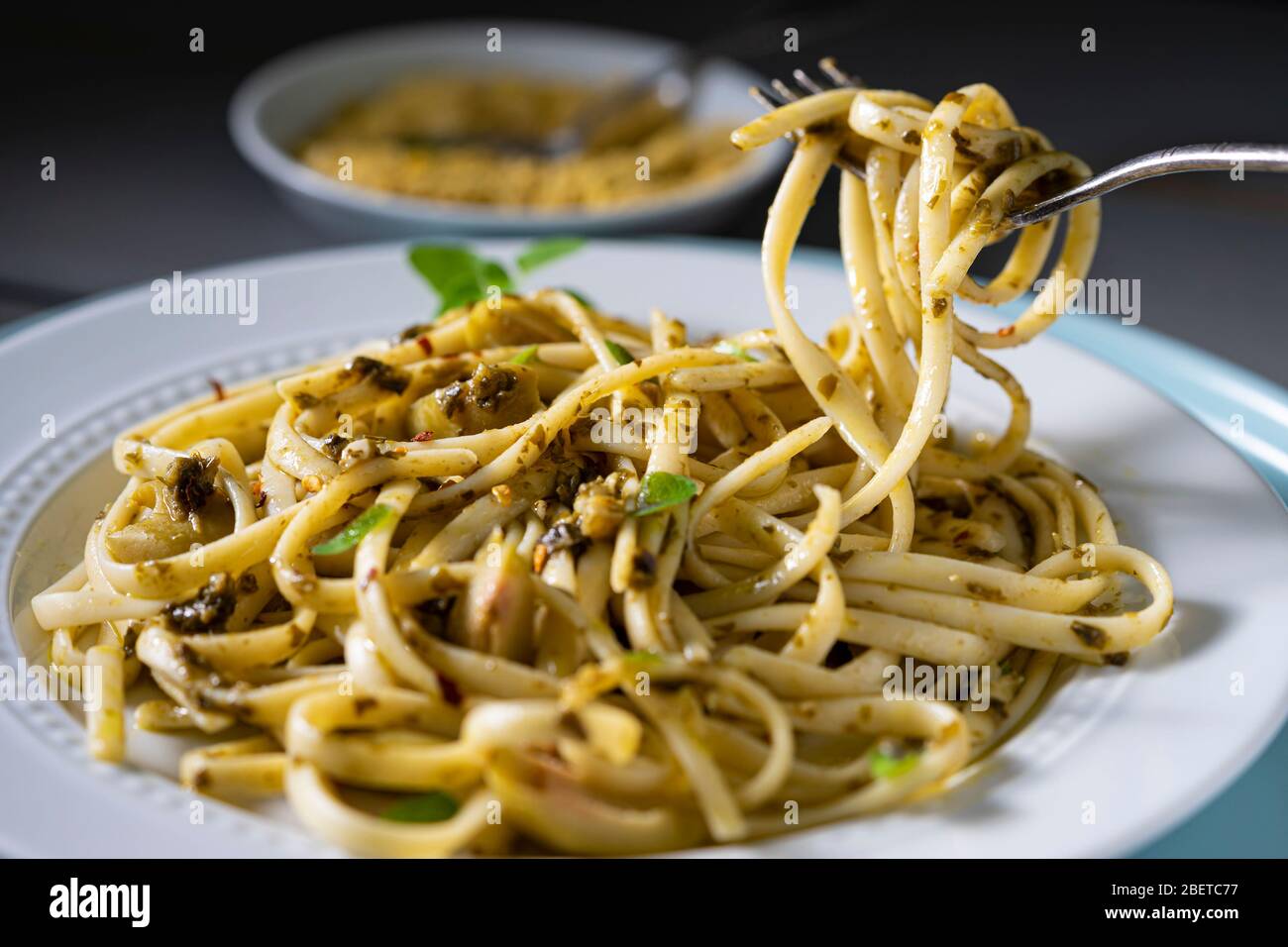 Vegan pasta dish. Fettuccine with pesto, green olives fresh thyme and