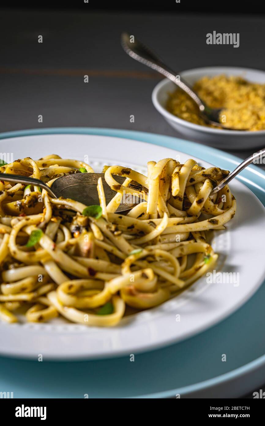 Vegan pasta dish. Fettuccine with pesto, green olives fresh thyme and