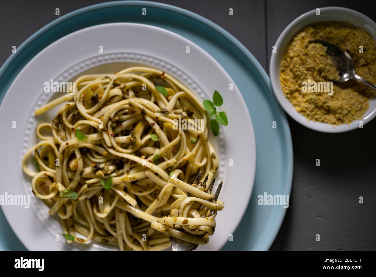 Vegan pasta dish. Fettuccine with pesto, green olives fresh thyme and