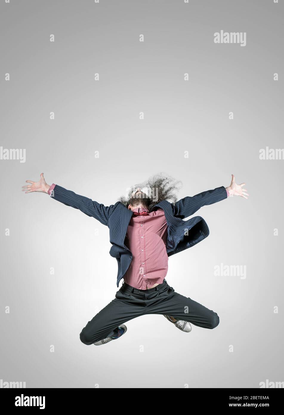 Skinny, elegant guy in a jumping pose Stock Photo