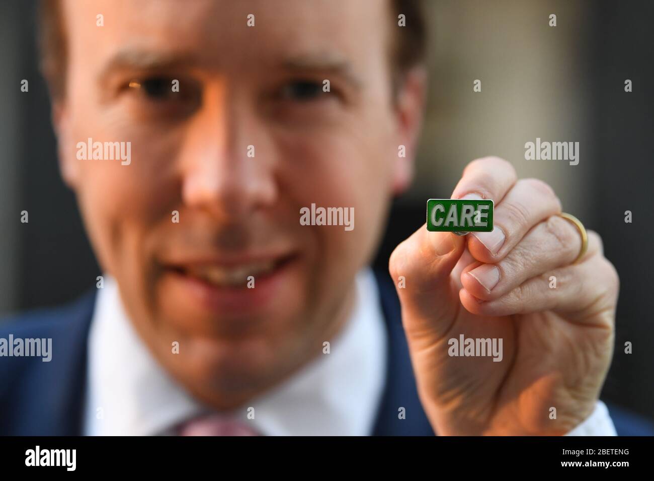 Health Secretary Matt Hancock showing the new 'Care' badge, described as a 'badge of honour' for social care workers so they can get the same public recognition as NHS staff, in Downing Street, London. Stock Photo