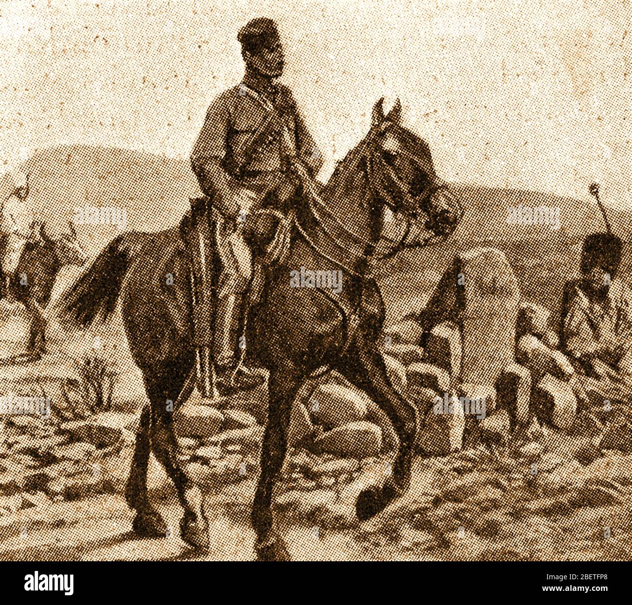 A Basuto mounted policeman at the grave of King Moshesh (Moshoeshoe) of Basutoland (1786-1870). He was also known as  Mshweshwe, Moshweshwe, or Moshesh, and had the original tribal names of Lepoqo and  Letlama. He  became a strong leader and is best known for uniting the various small tribes  to form the Sotho  nation - (present-day Lesotho). Stock Photo