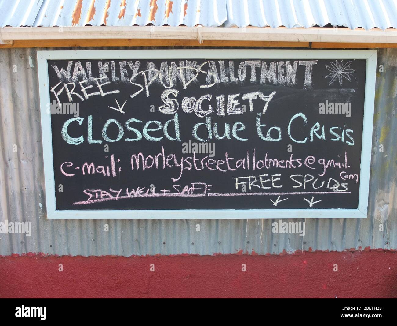 A sign on a blackboard outside Walkley Bank Allotment Society hut saying 'Closed due to CRISIS' [Coronavirus] and offering free spuds Stock Photo