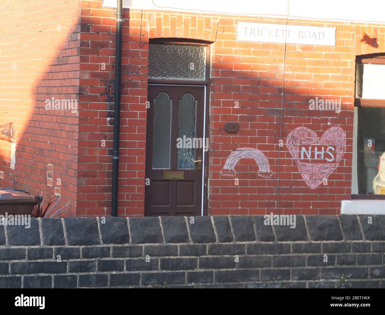 A message of support and gratitude to the NHS with a rainbow chalked on the wall of a house on Trickett Road, Sheffield during the Coronavirus crisis Stock Photo