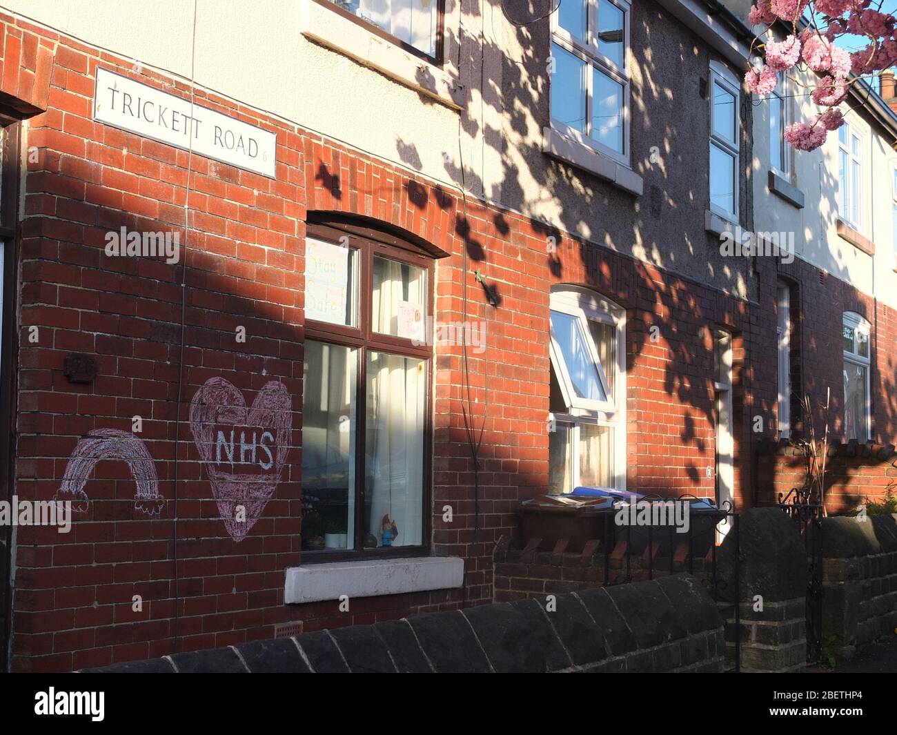 A message of support and gratitude to the NHS with a rainbow chalked on the wall of a house on Trickett Road, Sheffield during the Coronavirus crisis Stock Photo