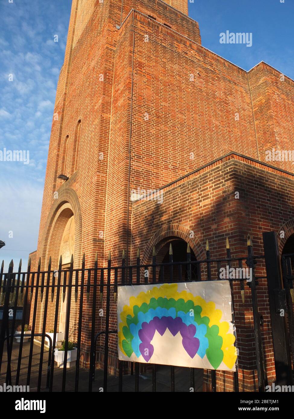 A sign of hope of a rainbow made of hearts on the railings of Scared Heart Catholic Church, Hillsborough, Sheffield, UK, closed due to Coronavirus Stock Photo