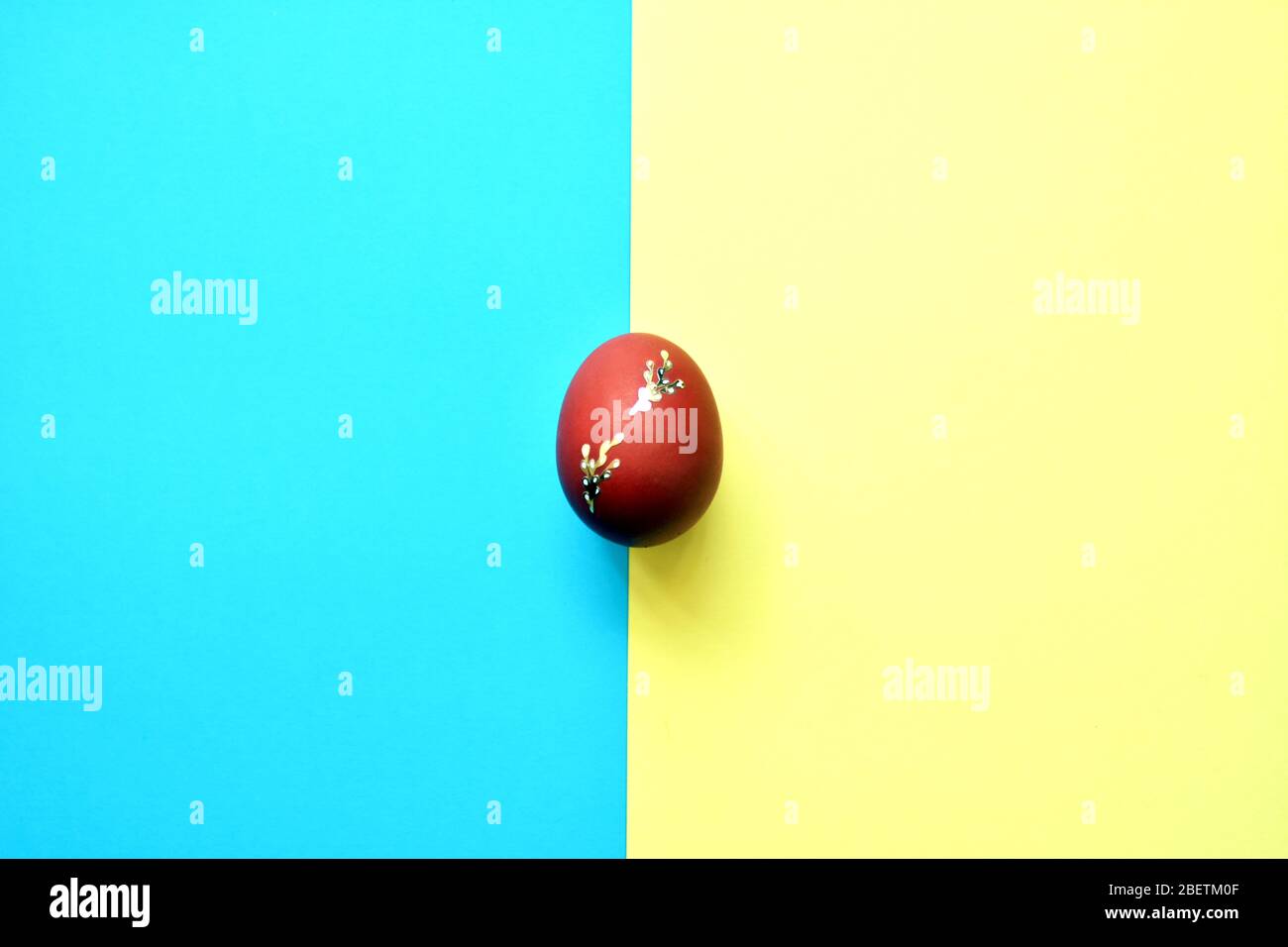 Easter egg on blue and yellow background . Stock Photo