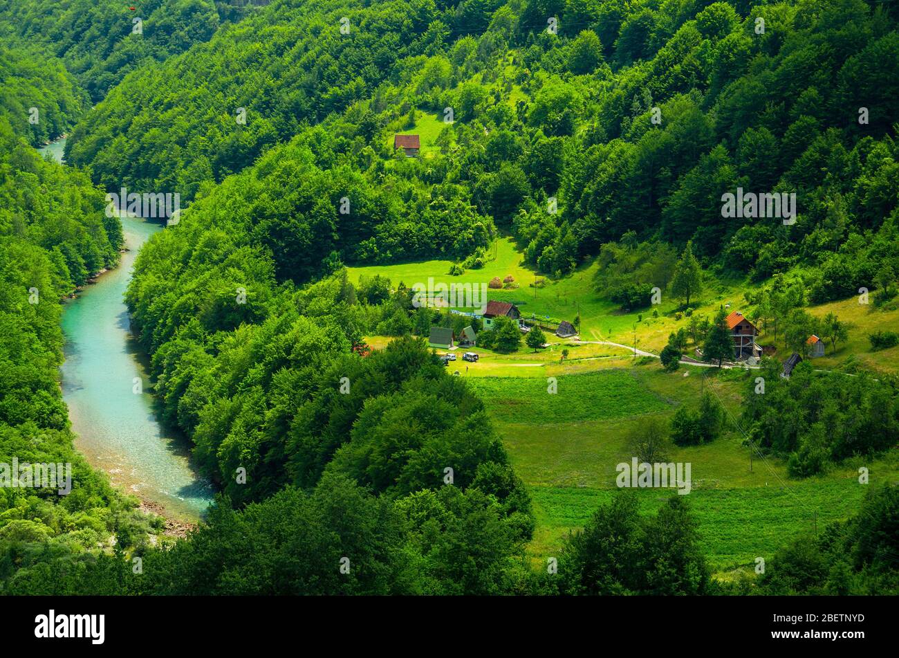 Small village houses in green forest near Tara river canyon, top