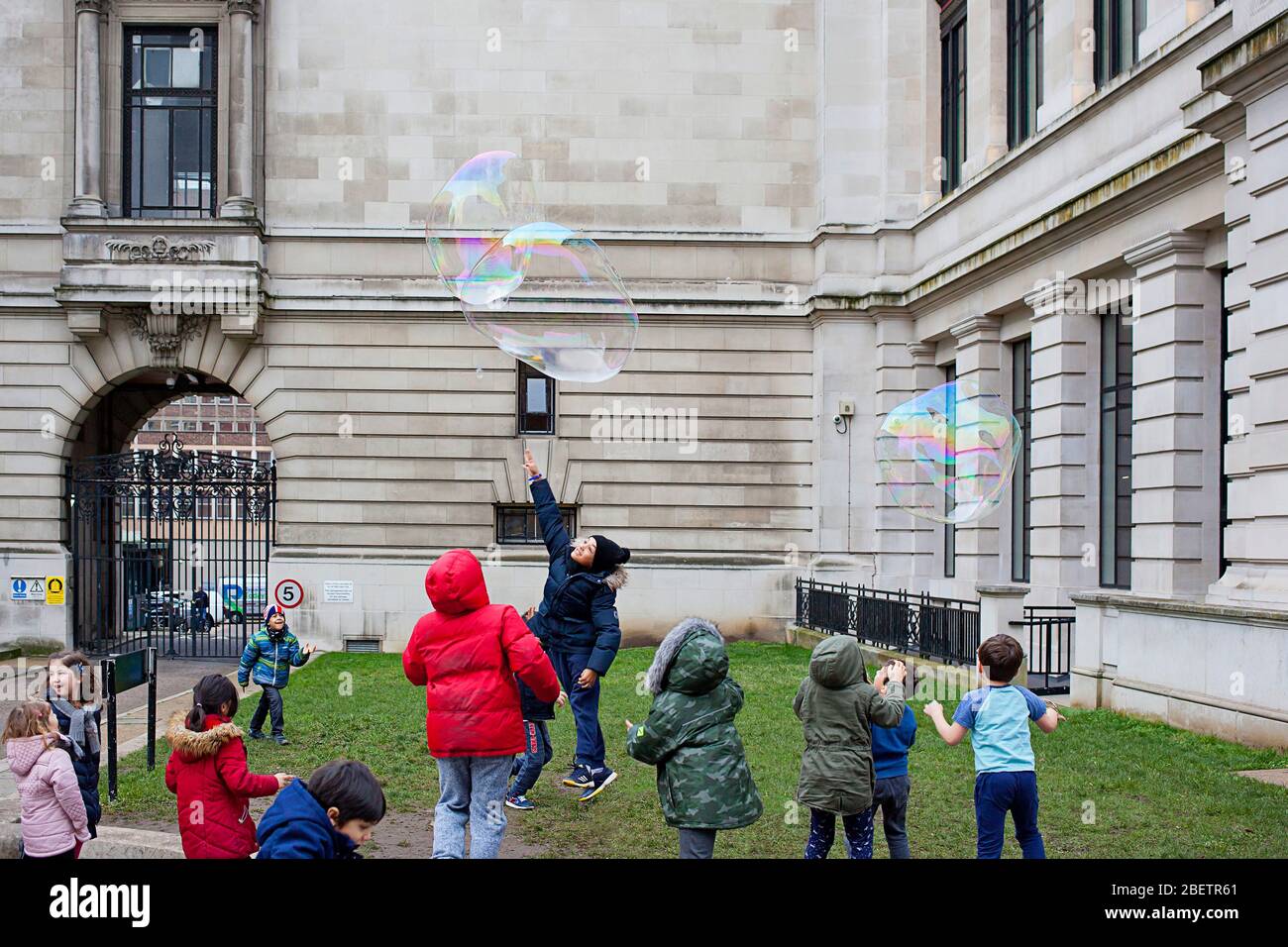 Street performer blowing giant soap bubbles Stock Photo