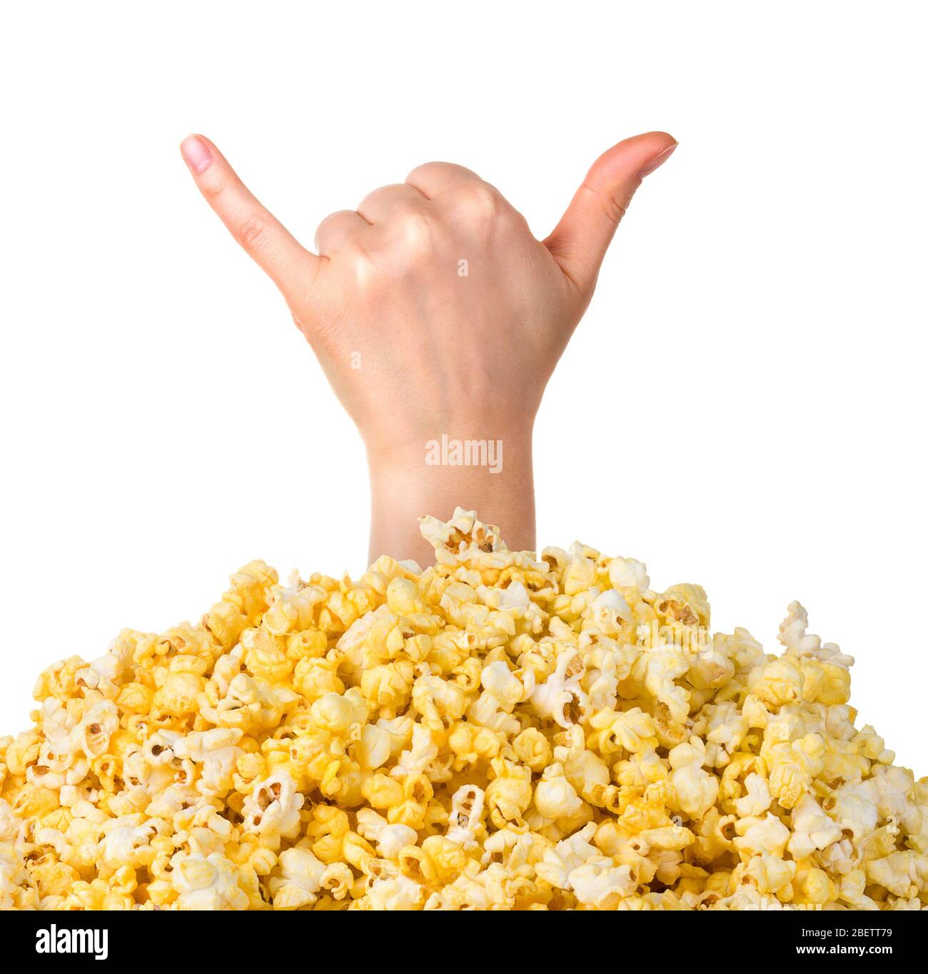Female hand sticks out of a pile of popcorn isolated on white background Stock Photo