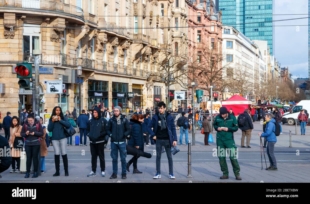 View of the Frankfurt city centre with unidentified people waiting for a traffic light. Hesse, Germany. Stock Photo