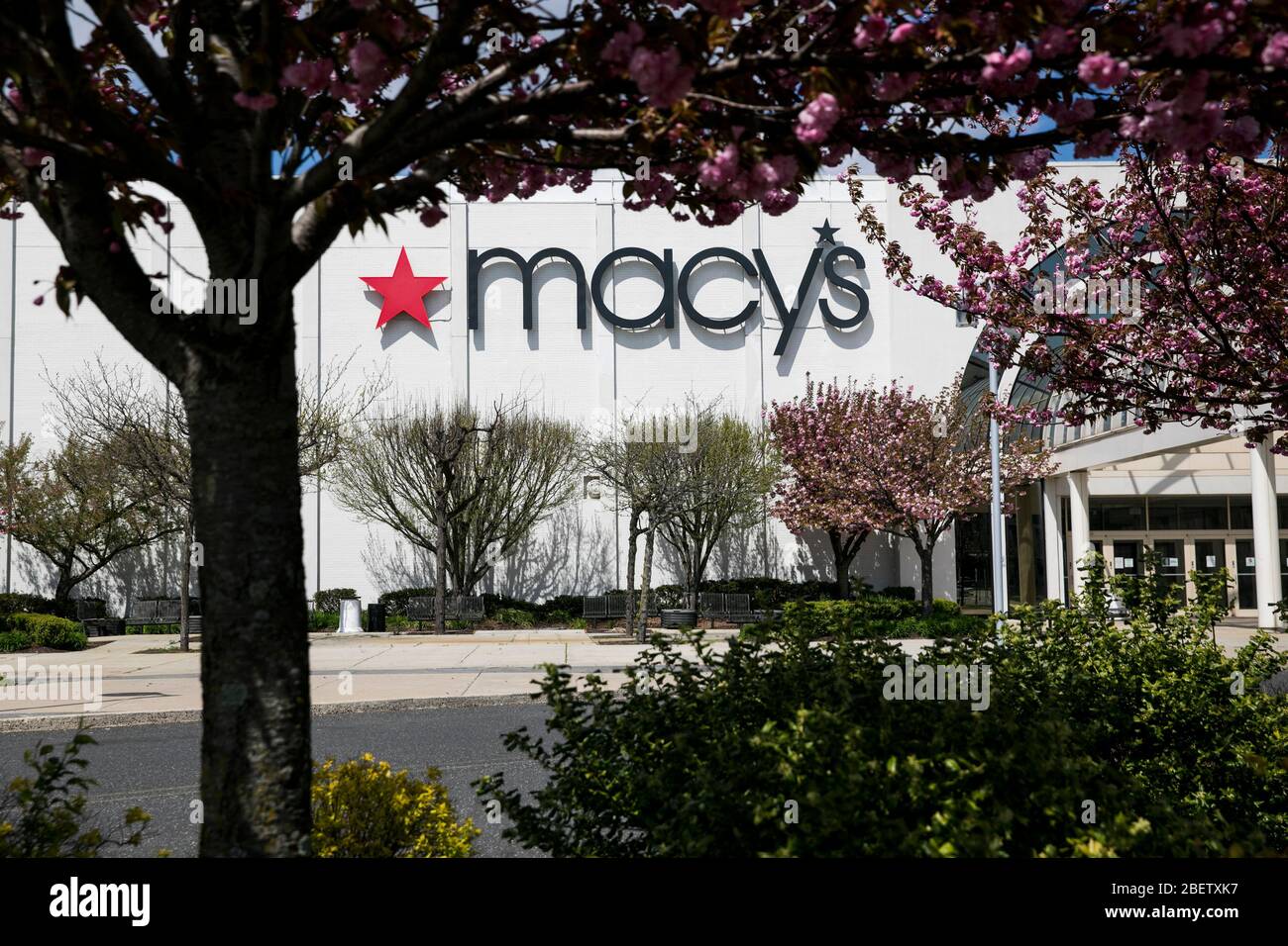 A logo sign outside of a Macy's retail store location in Cherry Hill