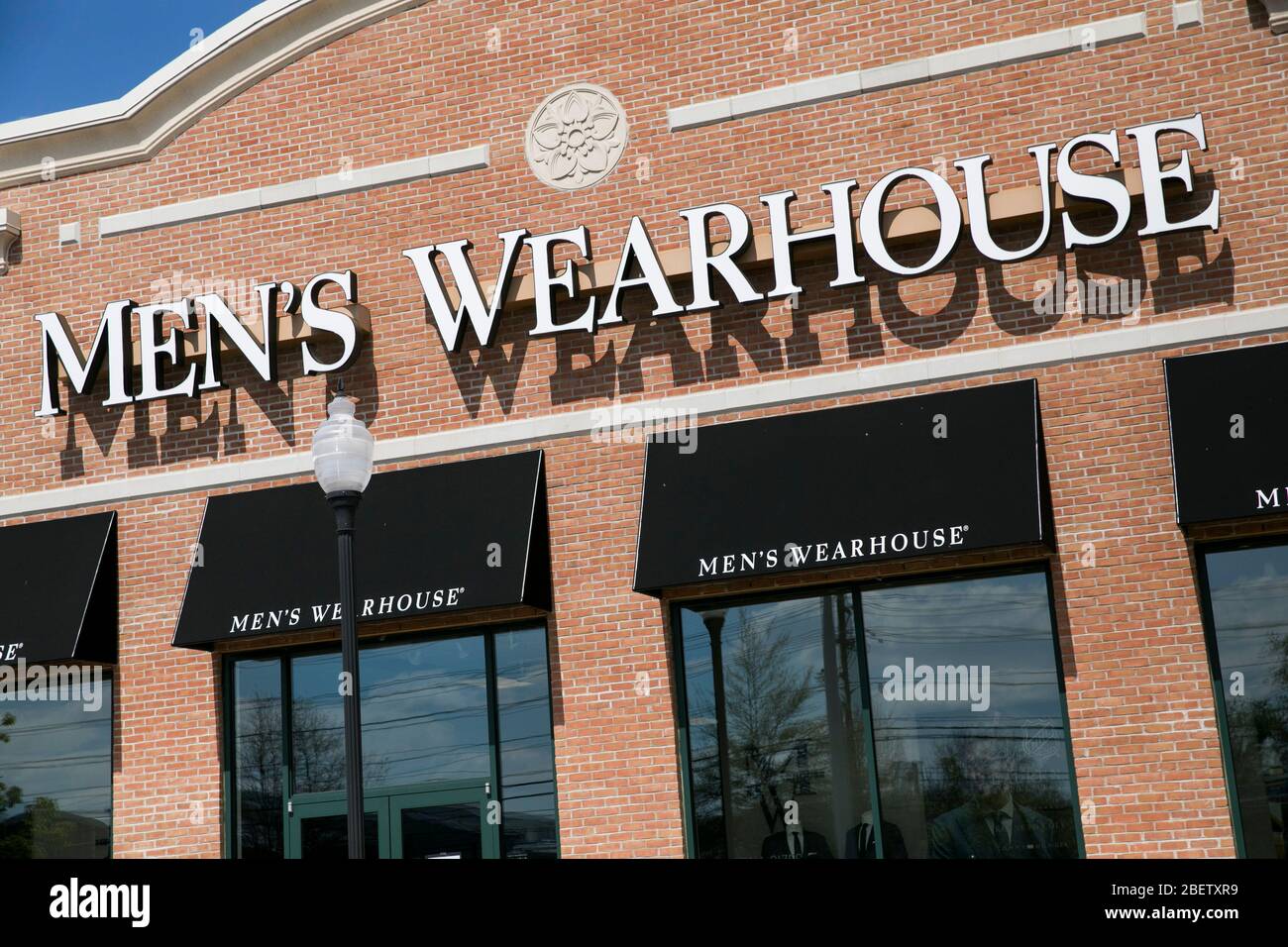 A logo sign outside of a Men's Wearhouse retail store location in Cherry Hill, New Jersey on April 11, 2020. Stock Photo