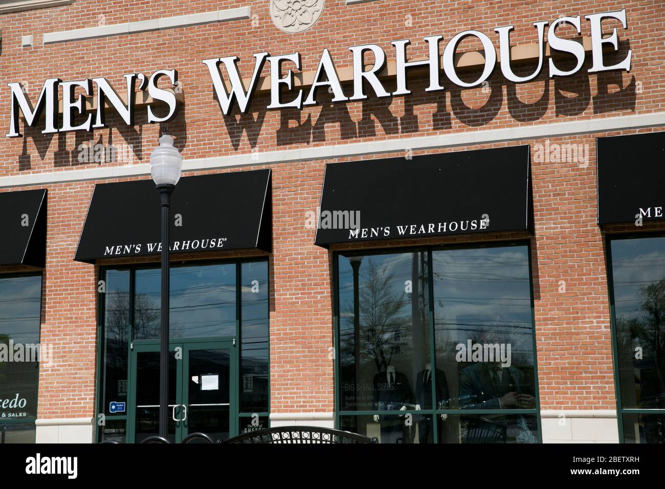 A logo sign outside of a Men's Wearhouse retail store location in Cherry Hill, New Jersey on April 11, 2020. Stock Photo