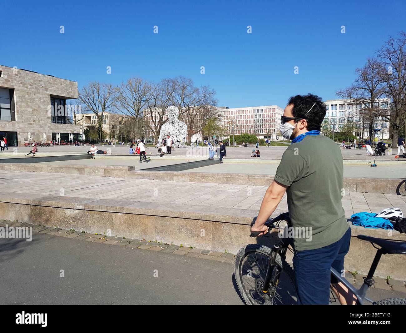 One person ( man / male biker ) wearing face mask / dust , protective or surgical mask while doing sport by bike during corona virus covid-19 lockdown Stock Photo