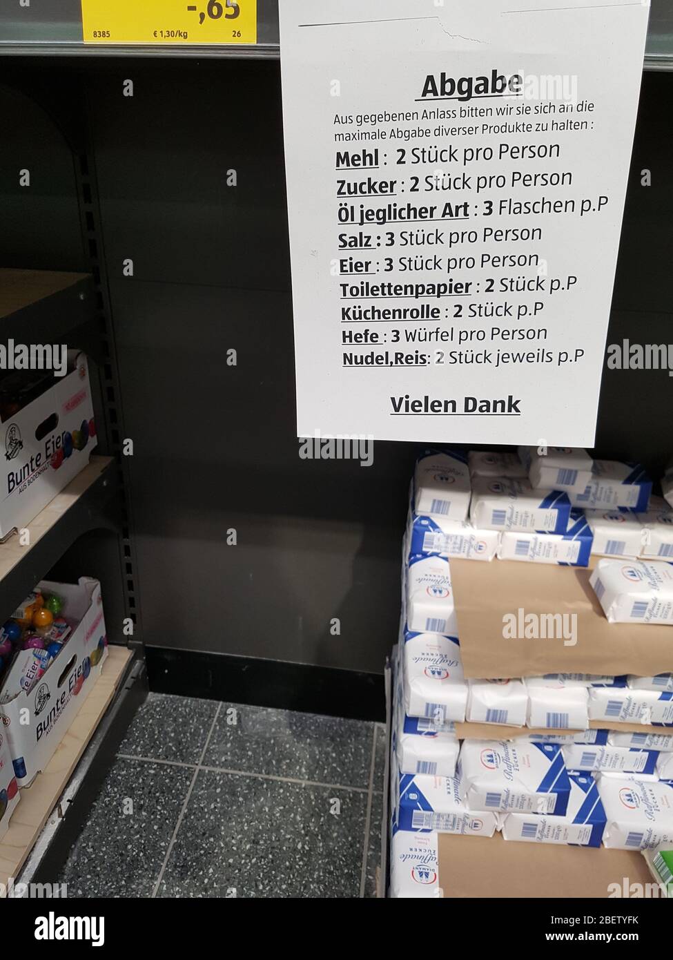 Shield / sign hanging on empty shelf in supermarket - restriction of products to limit number per person / household - panic hoarding ( Hamsterkäufe ) Stock Photo