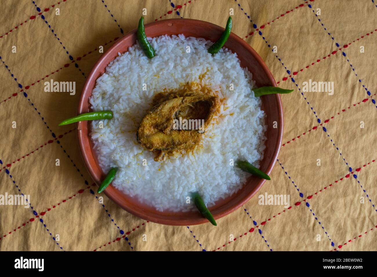 Traditional Bengali foods on earthen plate named Panta Ilish and Alu Vorta Stock Photo