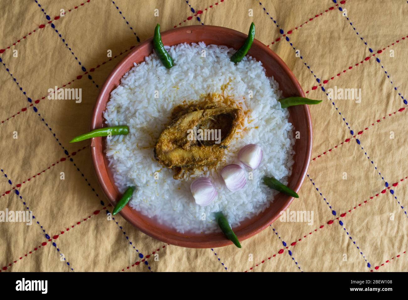 Traditional Bengali foods on earthen plate named Panta Ilish and Alu Vorta Stock Photo